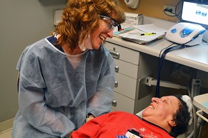 A dentist speaks with her patient.