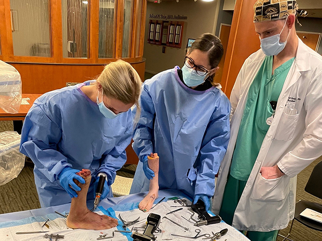 doctors surrounded around dissecting table