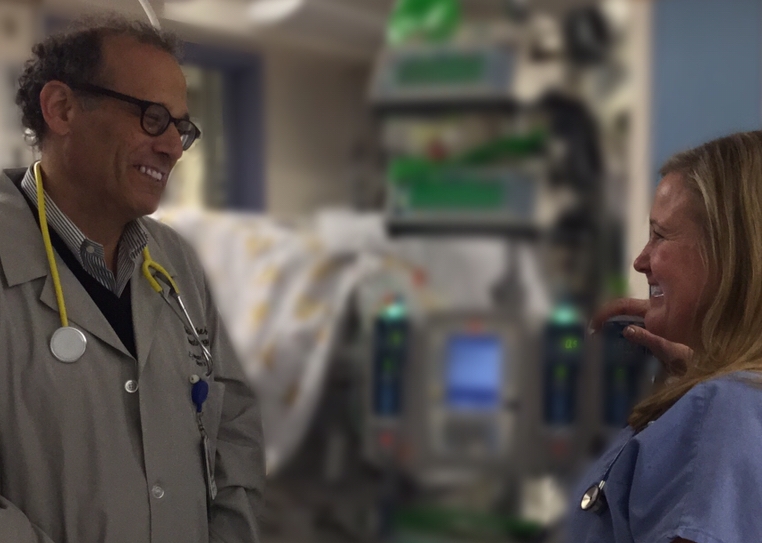 A doctor and nurse smile together.