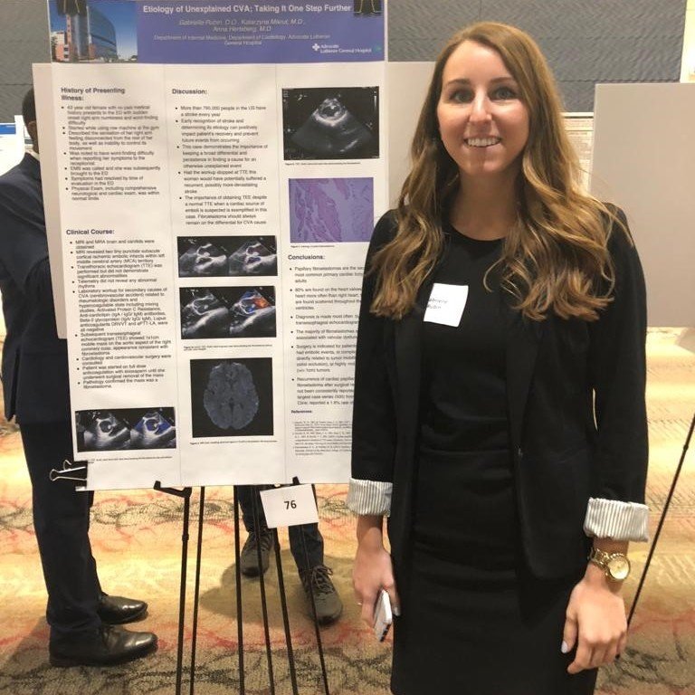 Woman standing in front of presentation board.