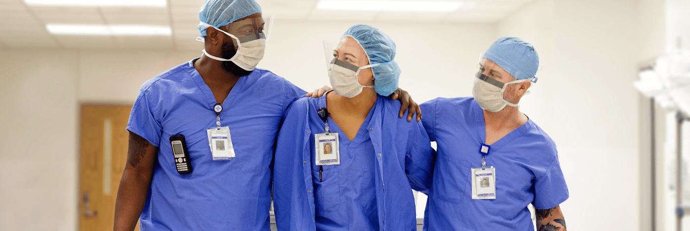 Health care workers with hands on shoulders