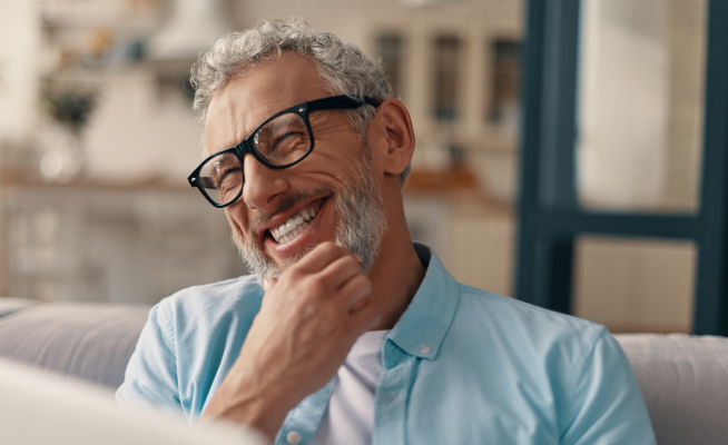 person with hand under chin smiling