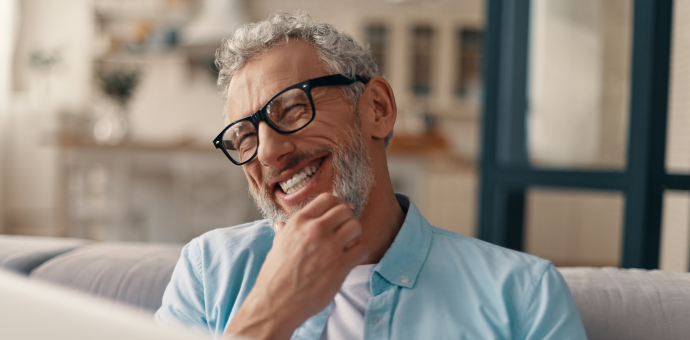 person with hand under chin smiling