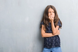 Young person biting fingernail