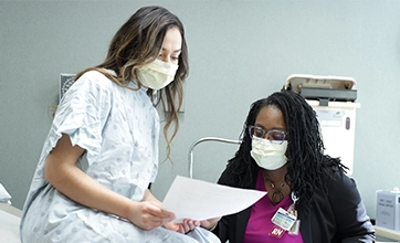 Health care worker going over report with community member