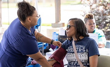 Health care worker taking blood pressure