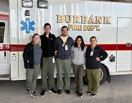 Group of people standing in front of ambulance