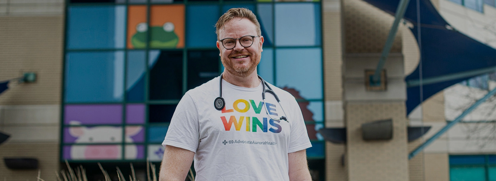 Careworker standing with a Love Wins shirt