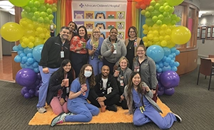 Group of people underneath arc of balloons