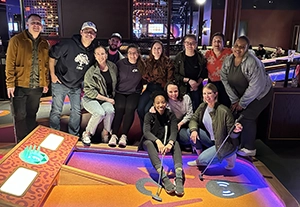 Group of people inside Puttstand building